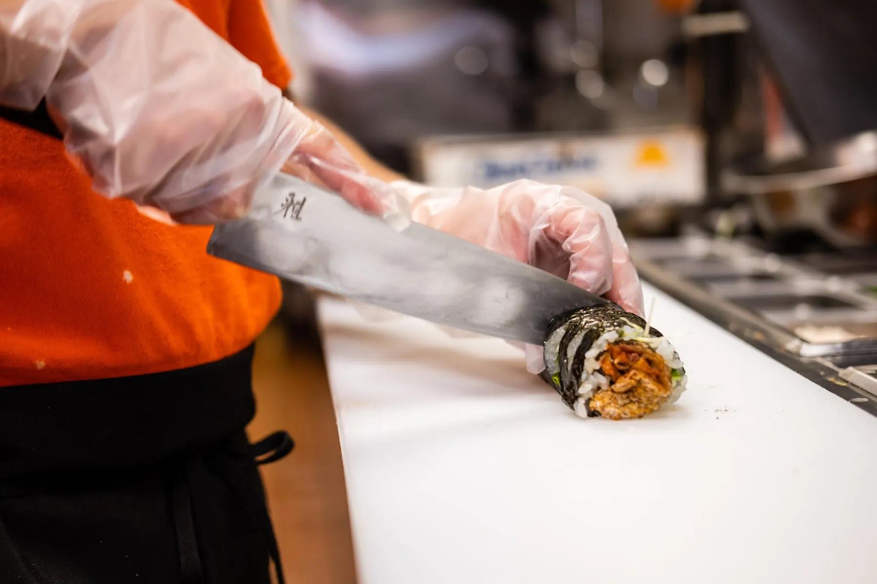 Sushi Rolls Being Cut